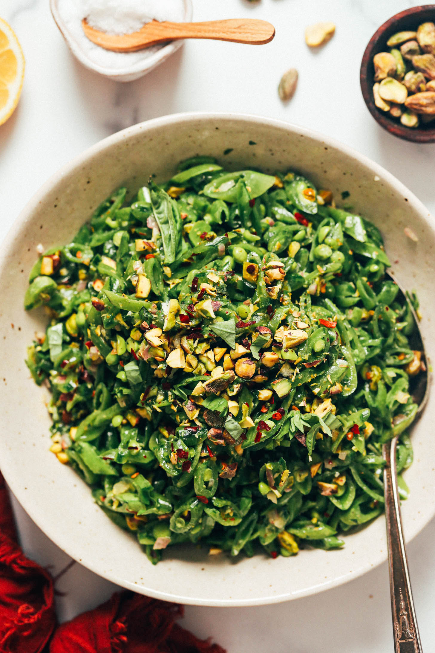 Large serving bowl piled high with fresh snap pea salad