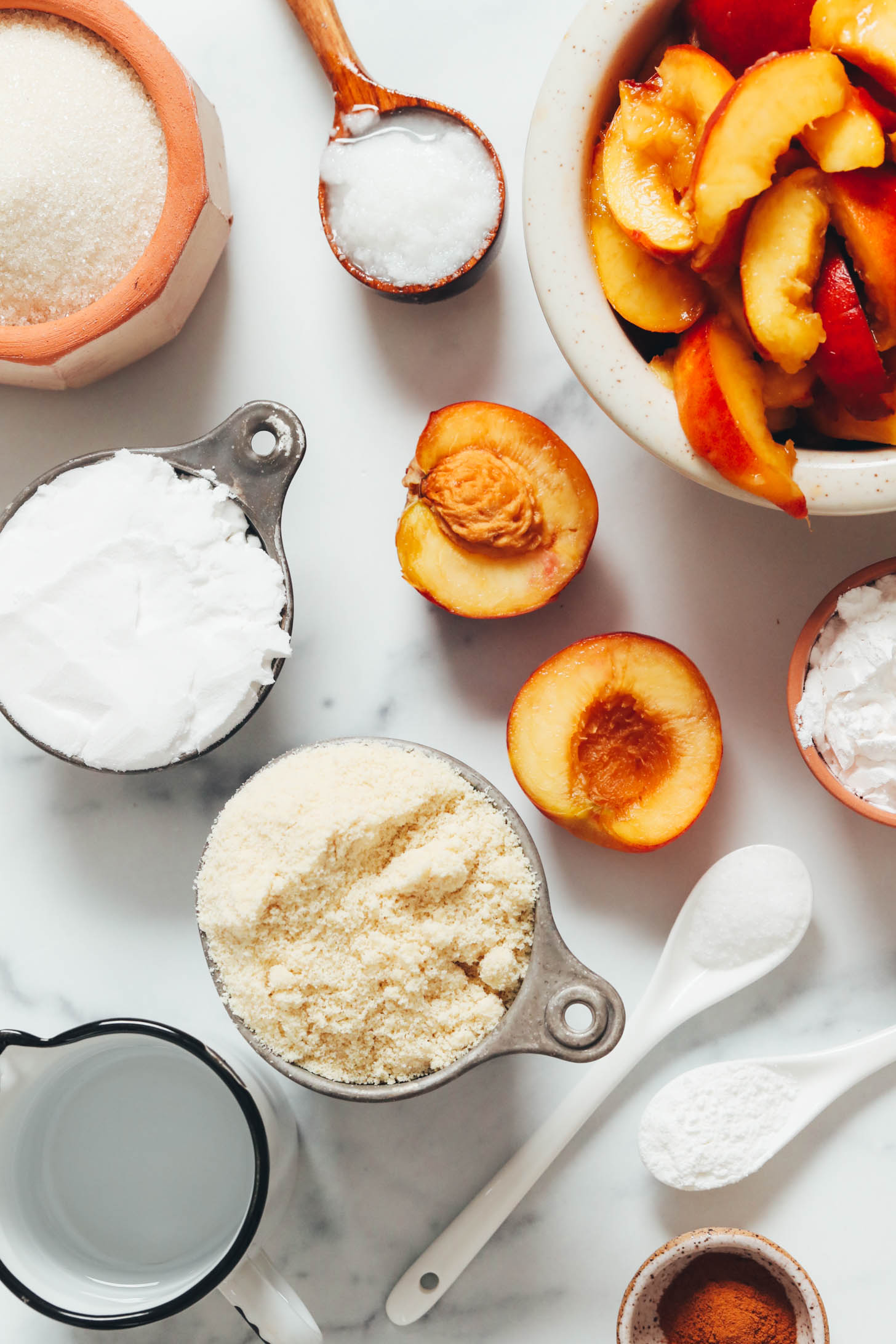 Fresh peaches, coconut oil, sugar, potato starch, almond flour, cold water, salt, baking powder, cinnamon, and arrowroot starch