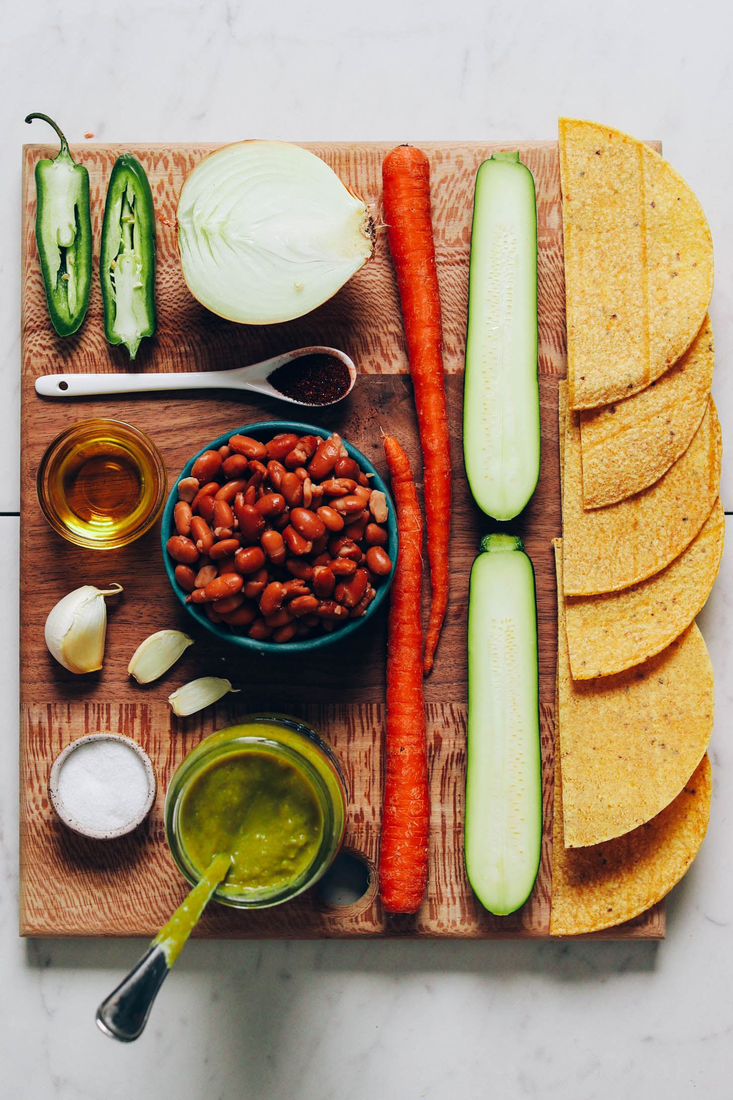 Serrano, onion, carrots, zucchini, tortillas, green enchilada sauce, salt, garlic, pinto beans, oil, and chili powder