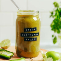 Spoon in a jar of homemade green enchilada sauce
