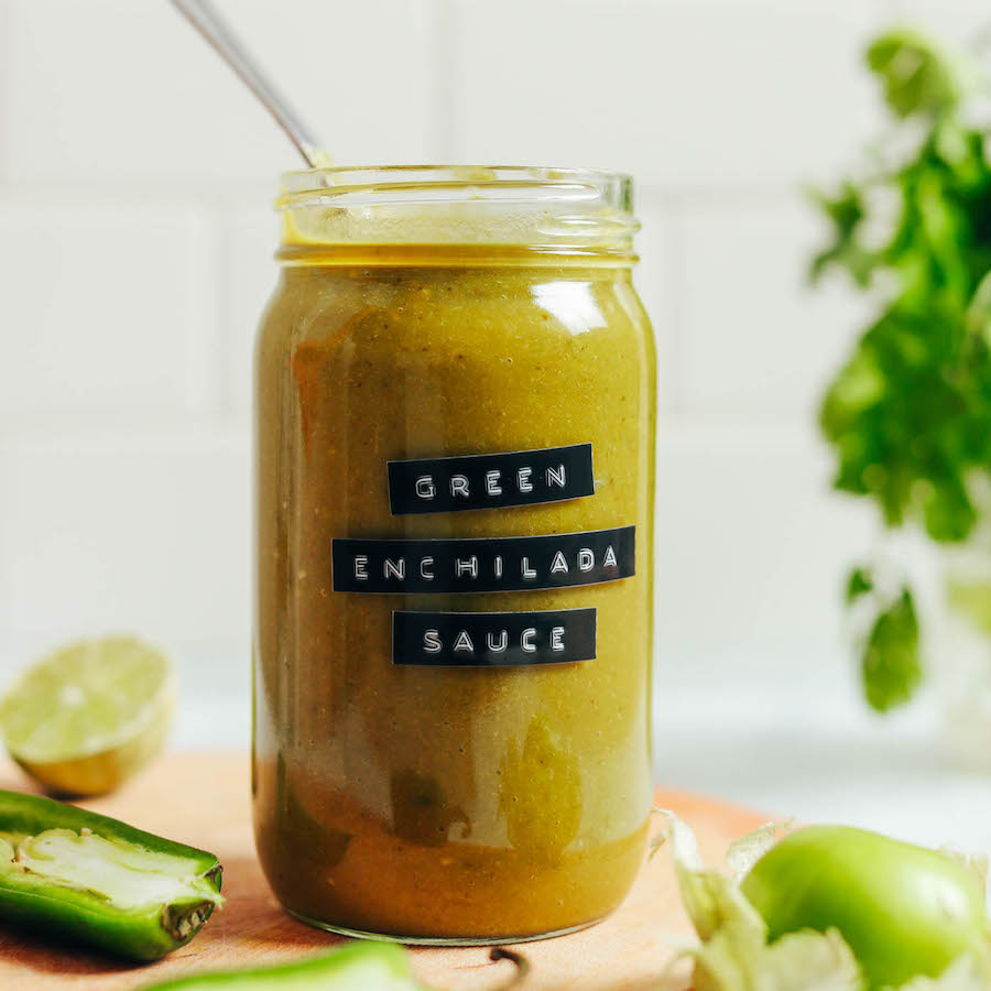 Spoon in a jar of homemade green enchilada sauce