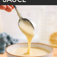 Spoon scooping easy vegan hollandaise sauce out of a ramekin