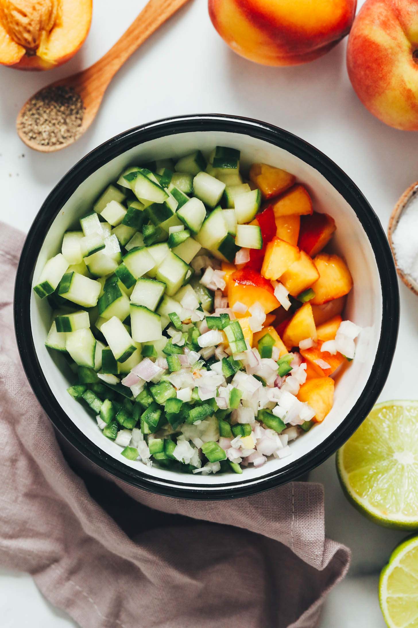 Bowl of diced cucumber, peaches, jalapeño, and shallot