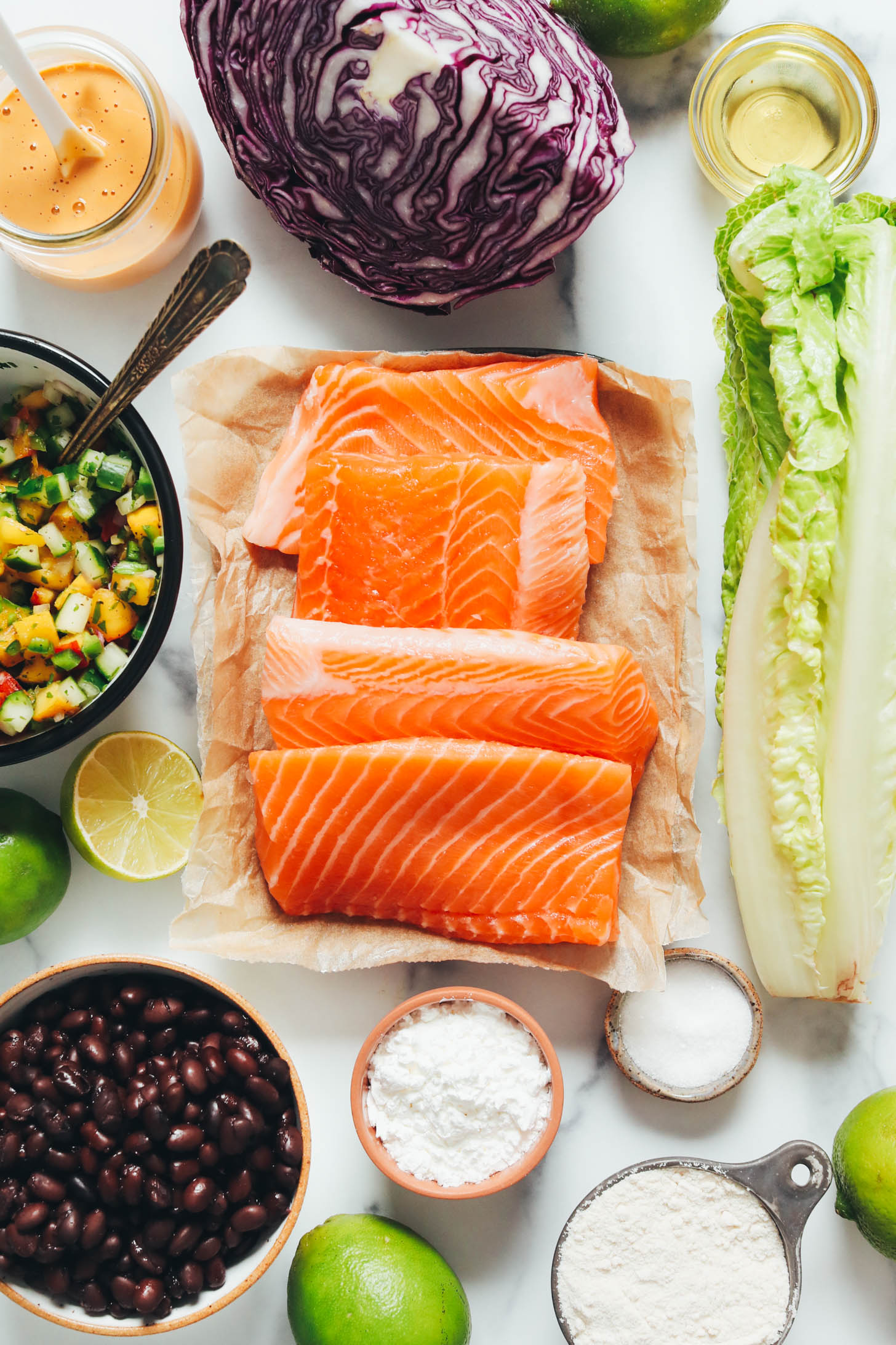 Smoky chipotle dressing, peach cucumber salsa, black beans, limes, salmon, corn starch, brown rice flour, salt, romaine, avocado oil, and cabbage