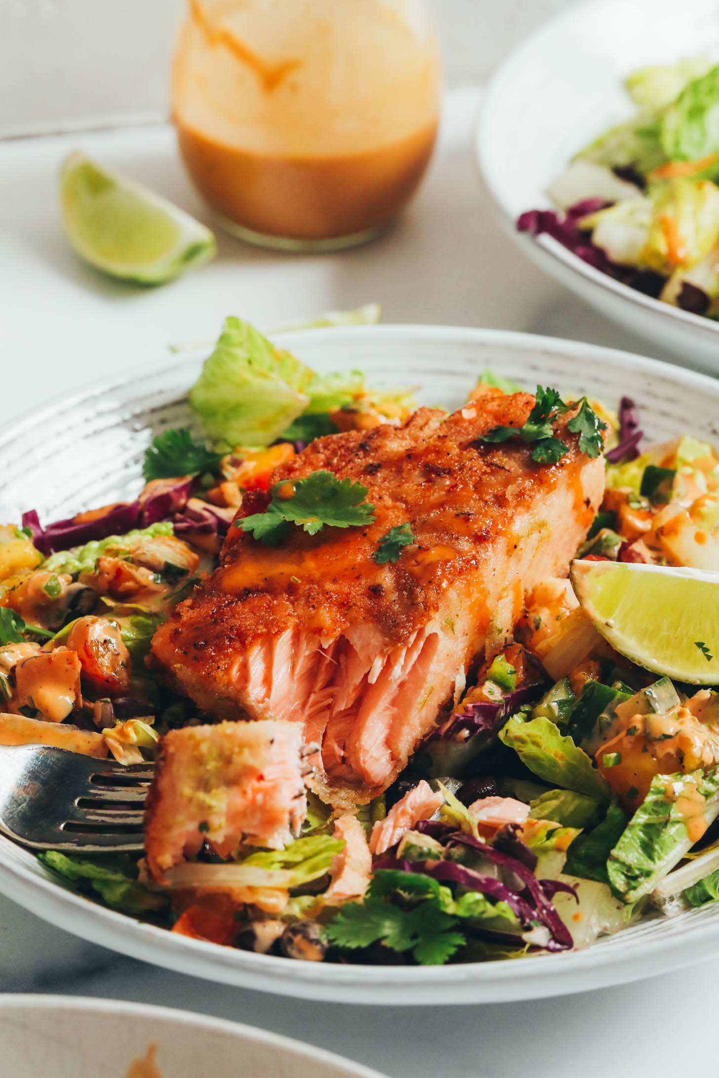 Flaky salmon filet on a salad