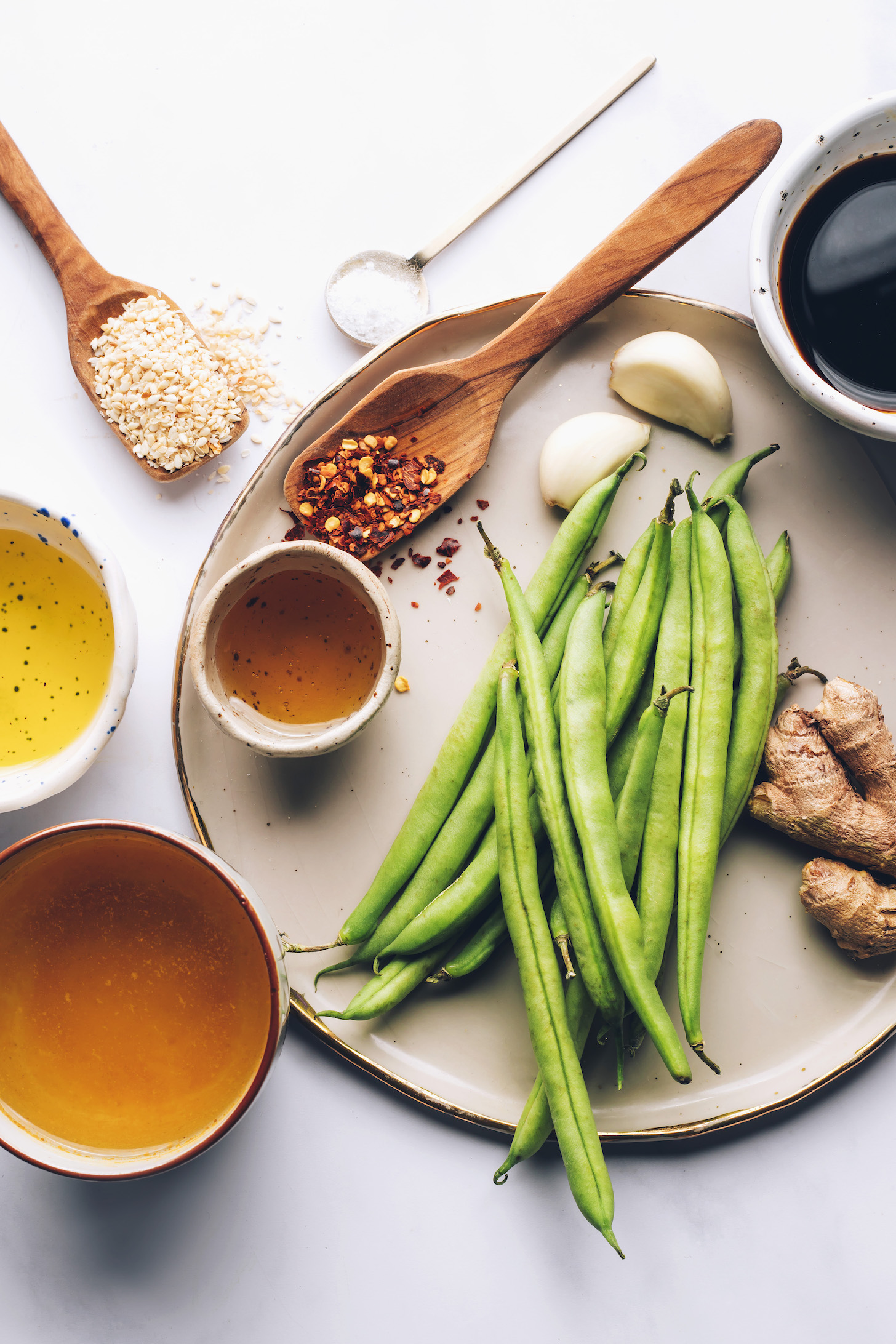 Green beans, ginger, garlic, tamari, red pepper flakes, salt, sesame seeds, avocado oil, maple syrup, and vegetable broth