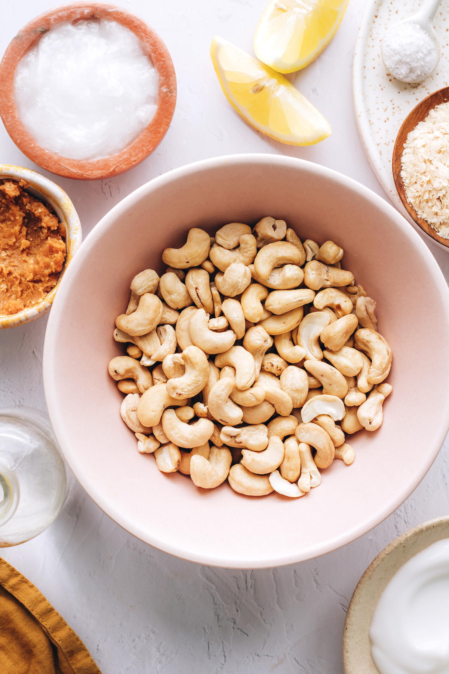 Cashews, coconut yogurt, nutritional yeast, salt, lemon wedges, coconut oil, miso paste, and vinegar