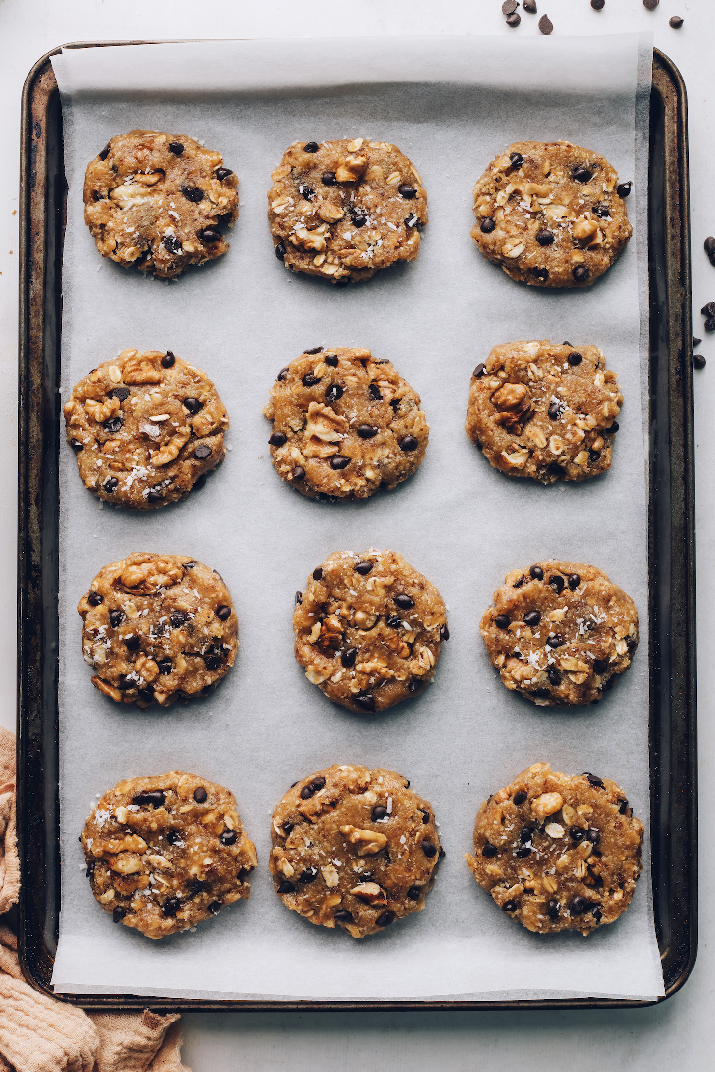 Flattened circles of cookie dough on a baking sheet