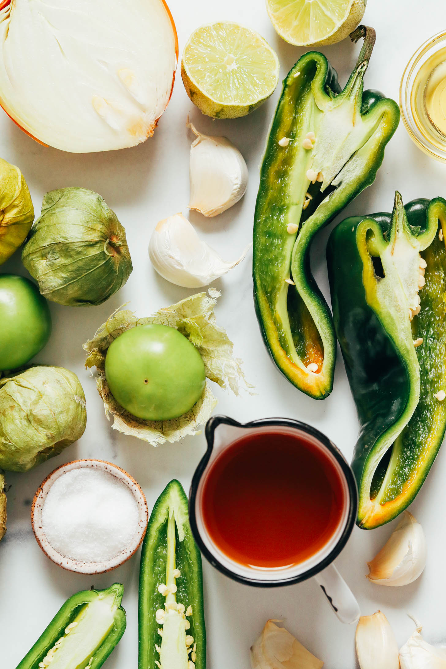 Onion, garlic, limes, poblanos, avocado oil, vegetable broth, jalapeños, salt, and tomatillos