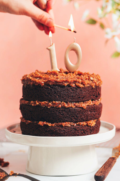Lighting a candle on our vegan gluten-free German chocolate cake