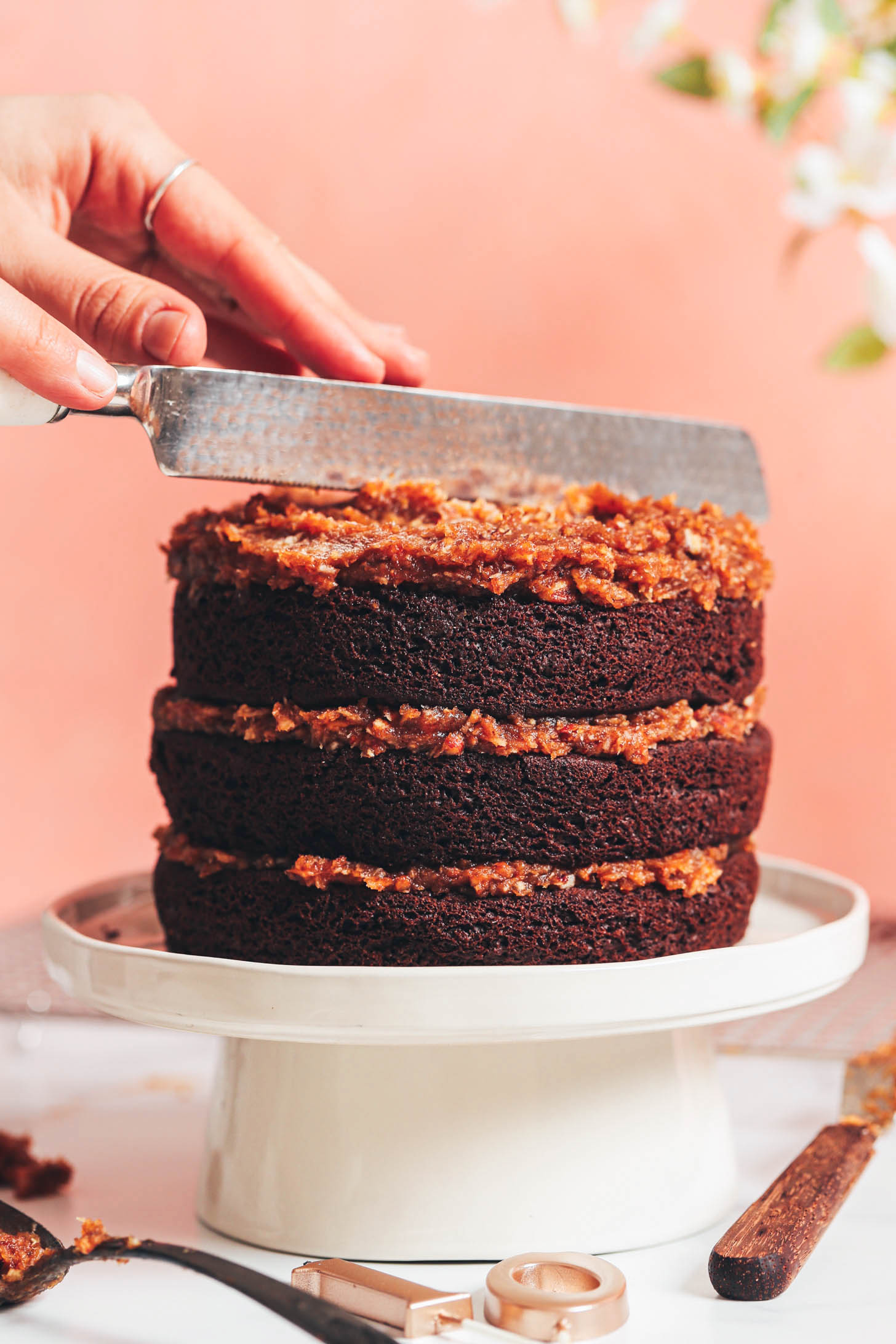 Knife slicing into a three layer German chocolate cake