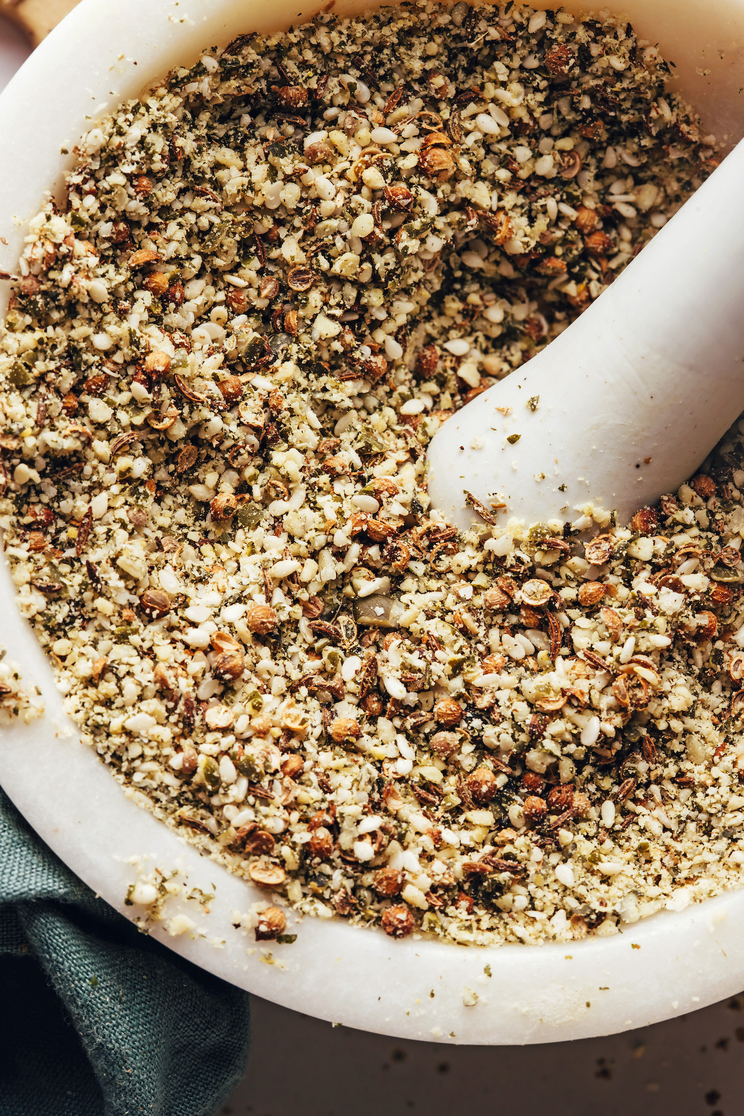 Close up shot of dukkah seasoning in a mortar and pestle