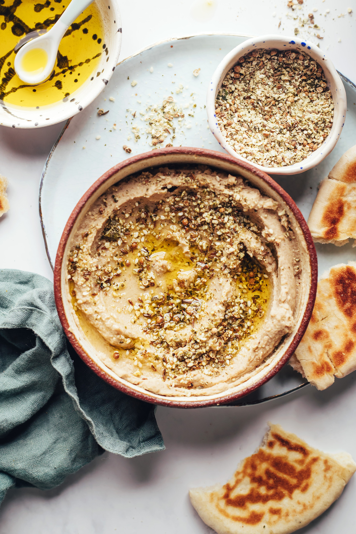 Bowl of hummus topped with olive oil and dukkah seasoning