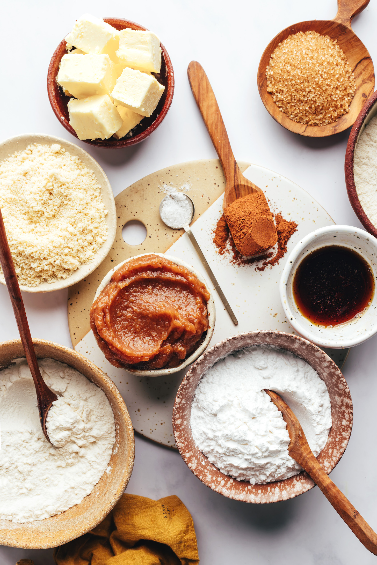 Vegan butter, almond flour, apple butter, sorghum flour, arrowroot starch, maple syrup, cinnamon, brown rice flour, and sugar
