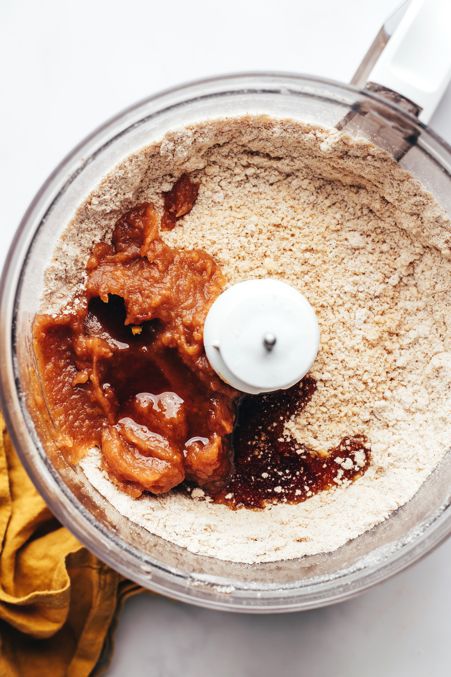 Apple butter, cinnamon, and maple syrup in a food processor with gluten-free flours and vegan butter
