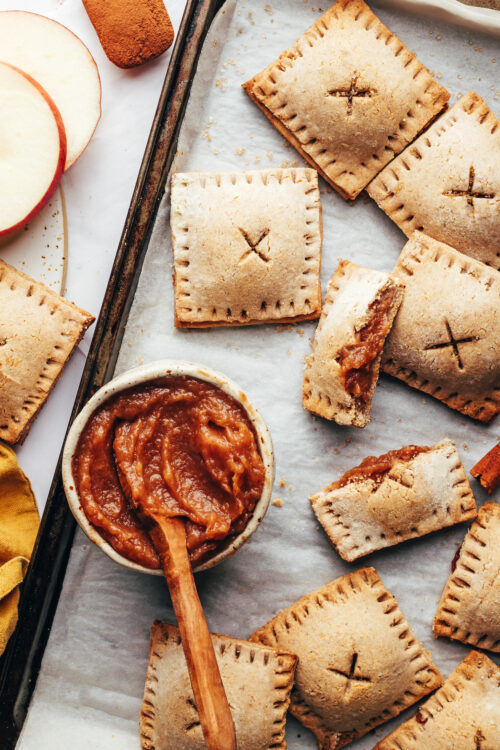 Baking sheet with a bowl of apple butter and homemade apple butter pop tarts