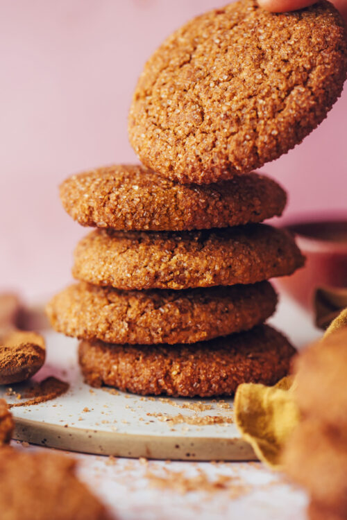 Picking up a pumpkin snickerdoodle from a stack of cookies