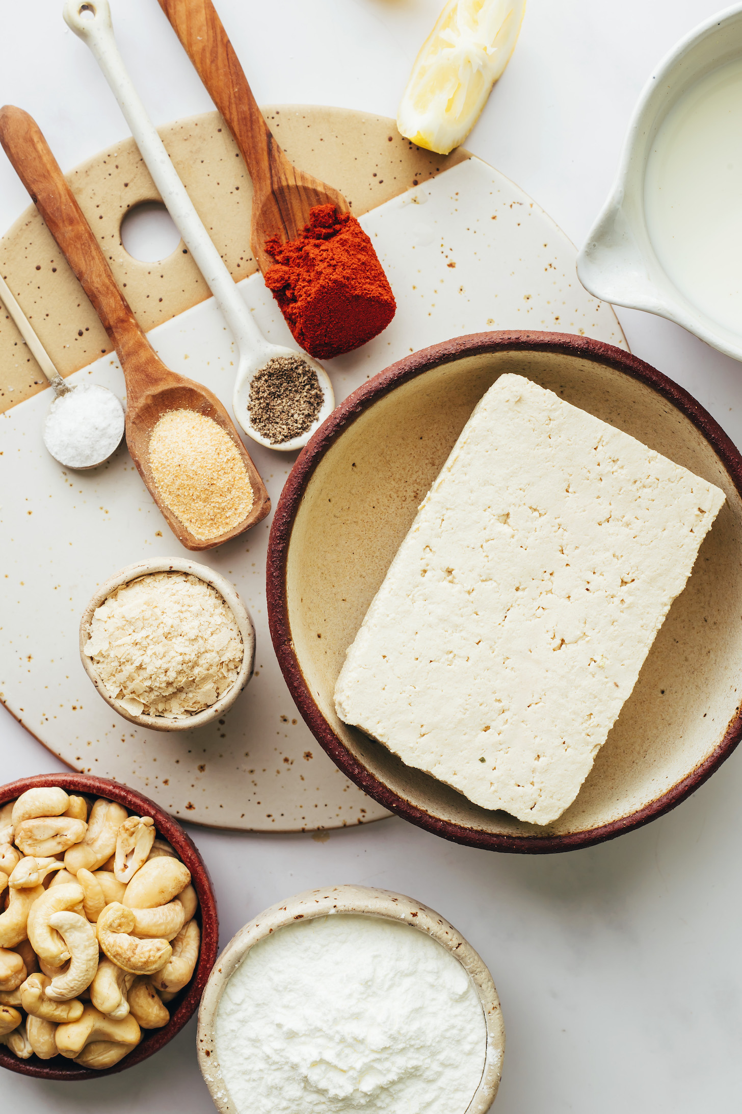 Salt, garlic powder, black pepper, smoked paprika, lemon, almond milk, tofu, cornstarch, nutritional yeast. and cashews