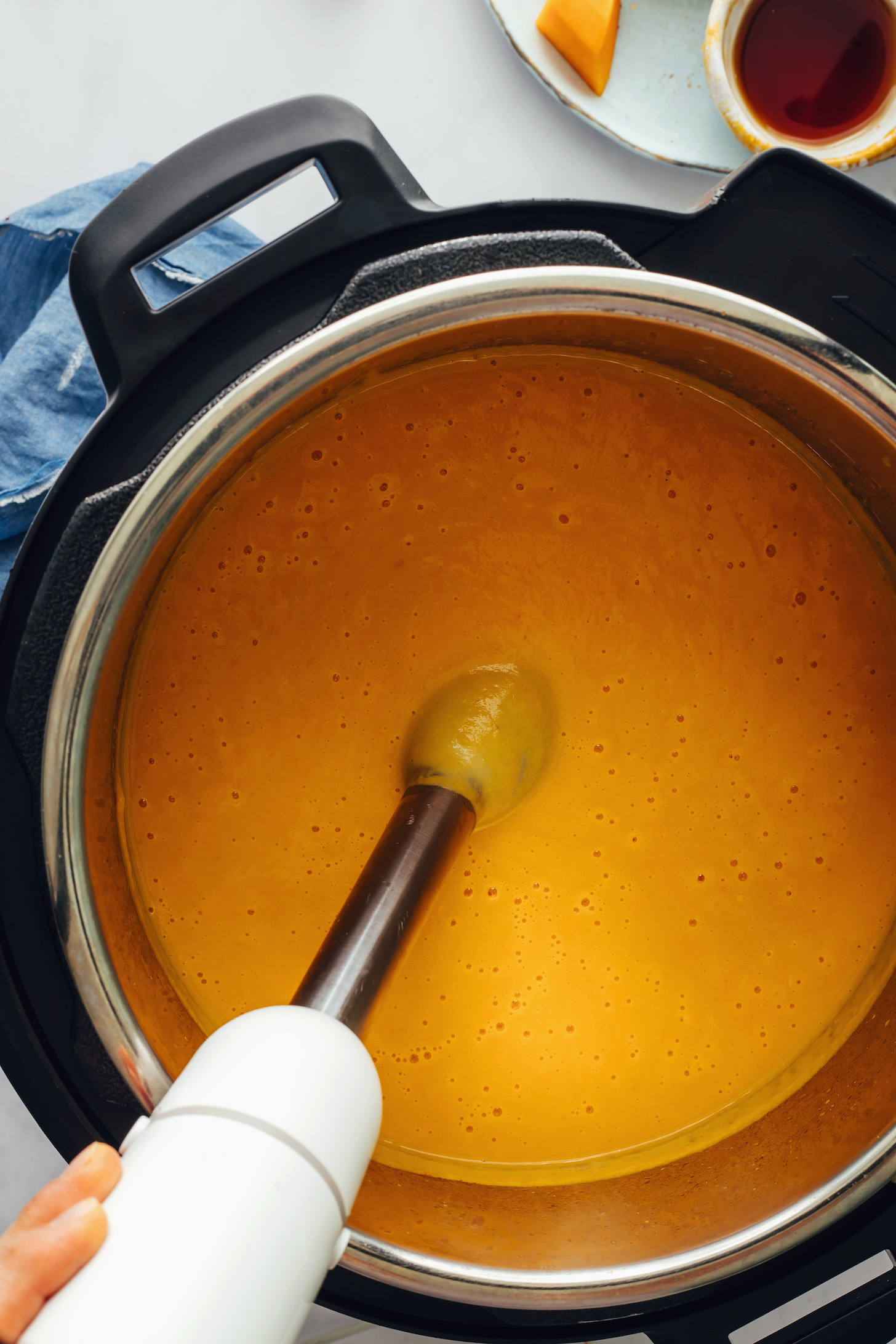 Using an immersion blender to purée butternut squash soup in the Instant Pot