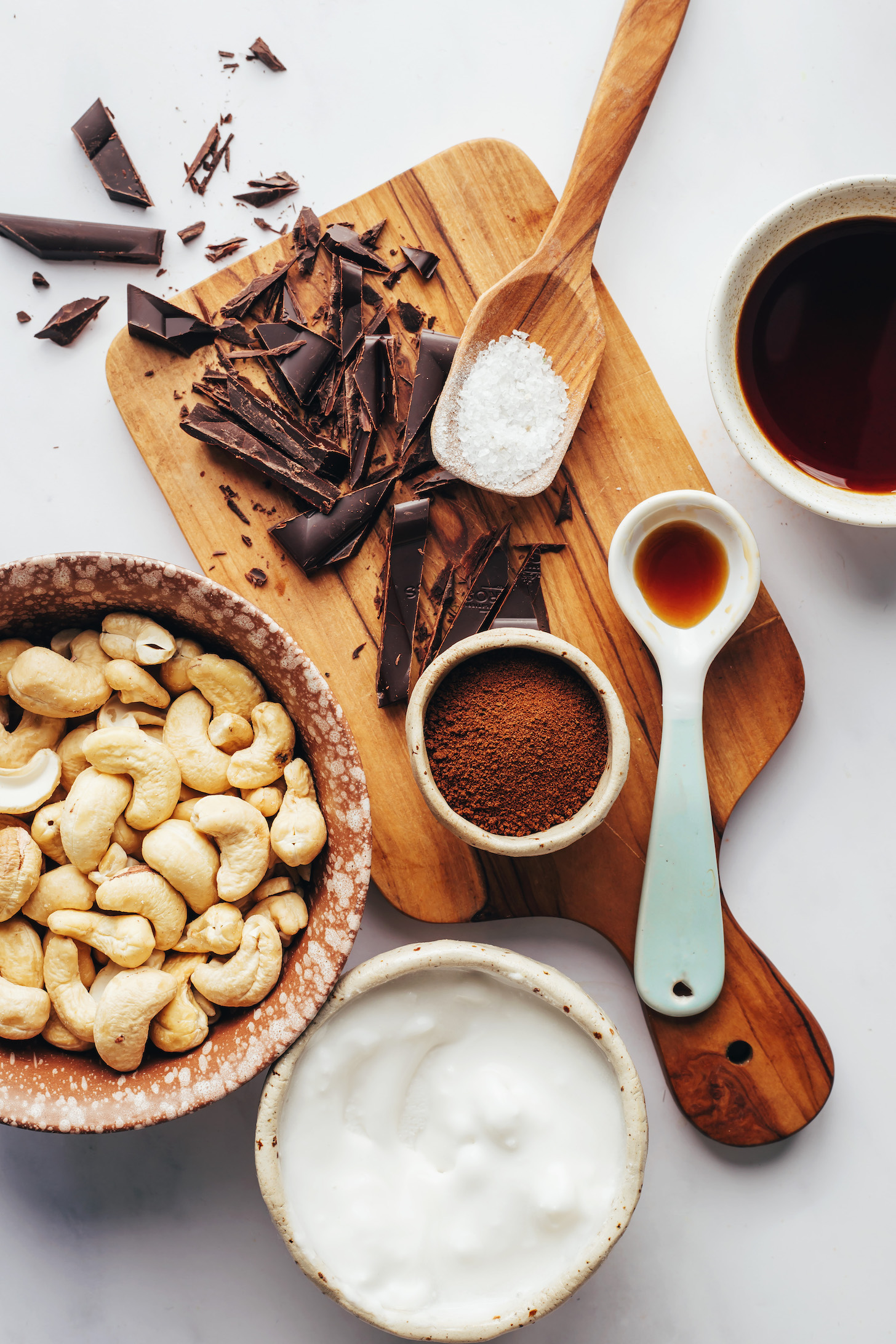 Cashews, chopped dark chocolate, salt, maple syrup, vanilla, cocoa powder, and coconut milk
