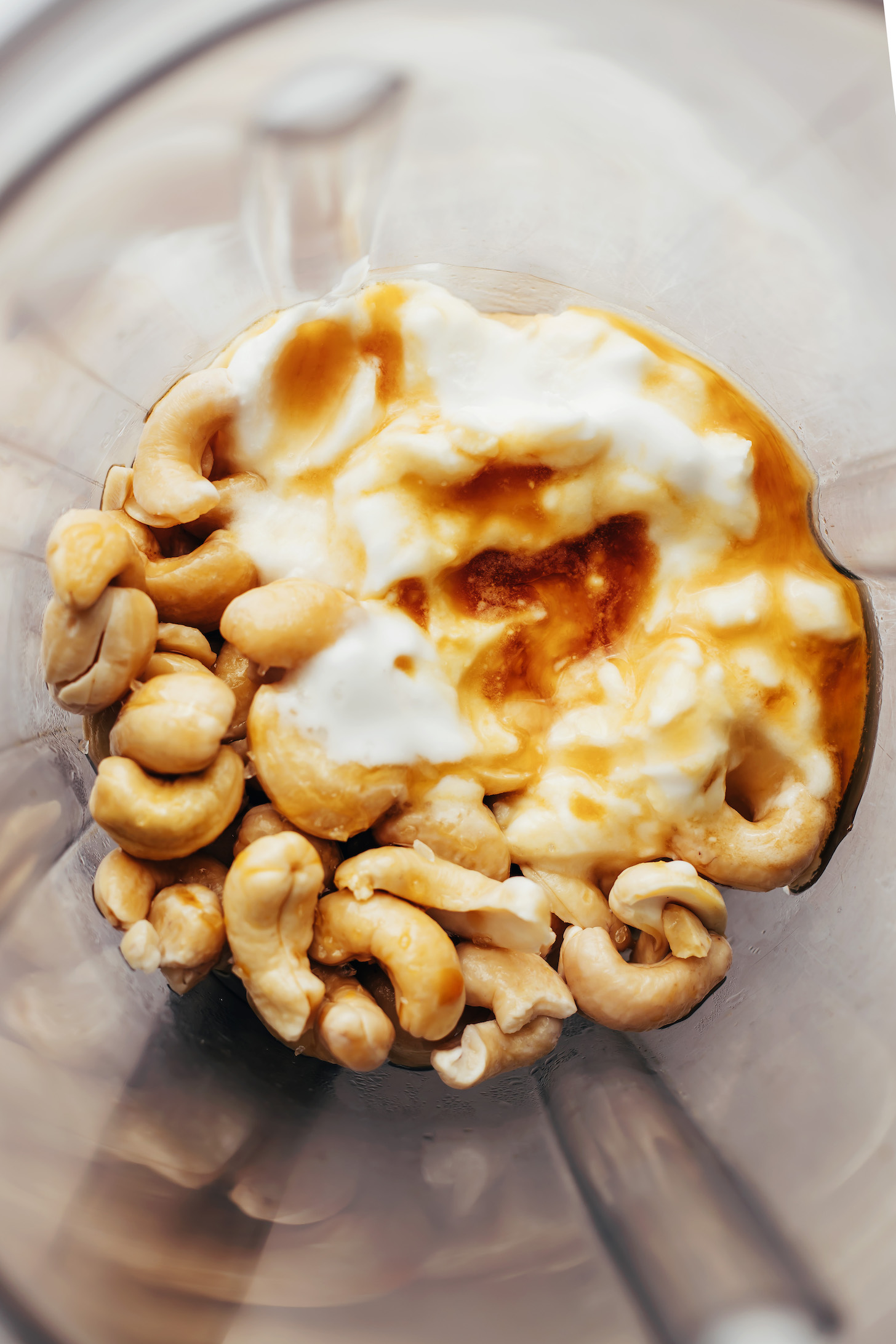 Blender with cashews, maple syrup, vanilla, coconut milk, coffee, and salt