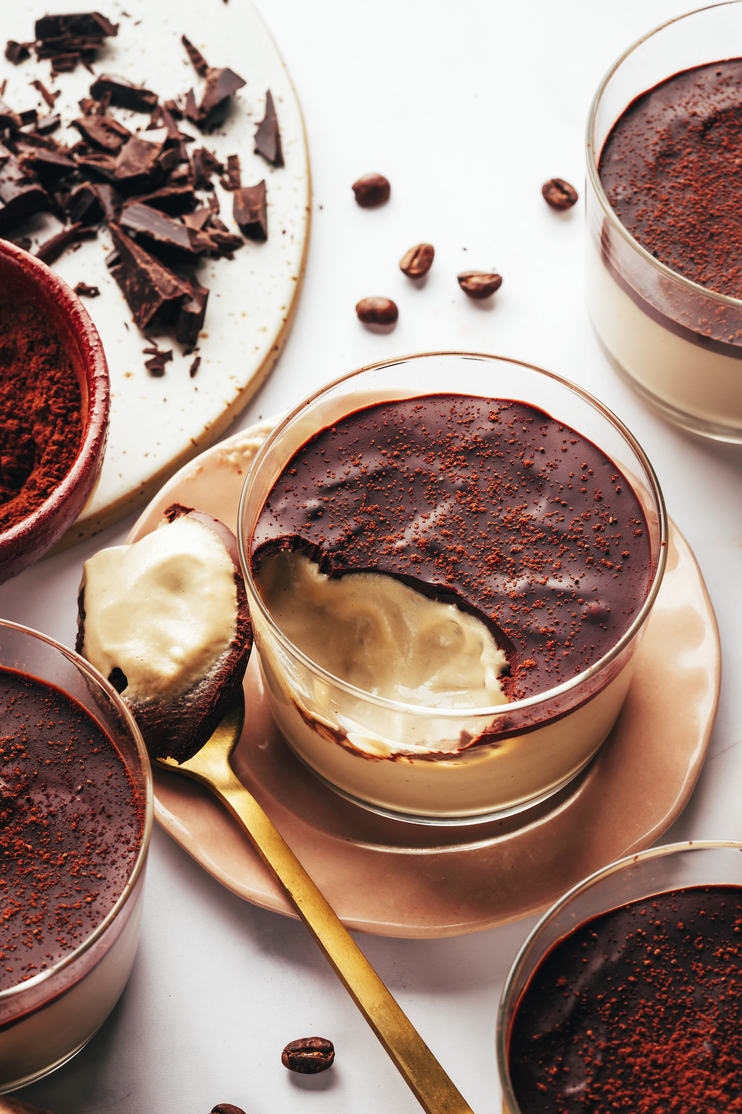 Spoon resting beside a dessert cup of vegan tiramisu pudding