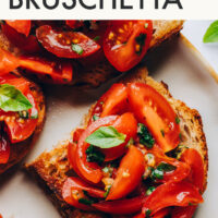 Slices of crusty bread topped with tomatoes for cherry tomato bruschetta