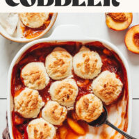 Baking dish of our Easy Peach Cobbler recipe with text above it that says vegan and gluten-free