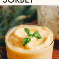 Glass dessert cup filled with creamy DIY Dole Whip with text above it reading 5-Minute Pineapple Sorbet