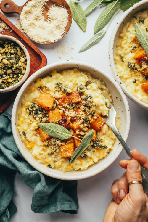 Holding a spoon in a bowl of Instant Pot butternut squash risotto