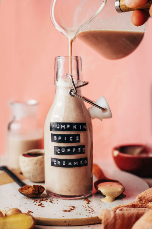 Pouring homemade pumpkin spice coffee creamer into a bottle