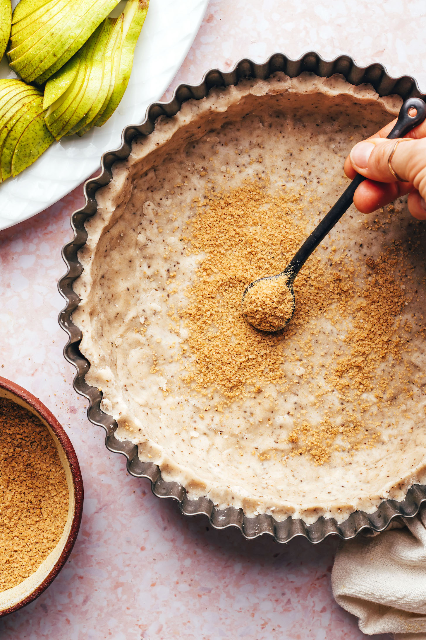 Sprinkling sugar onto an unbaked tart crust