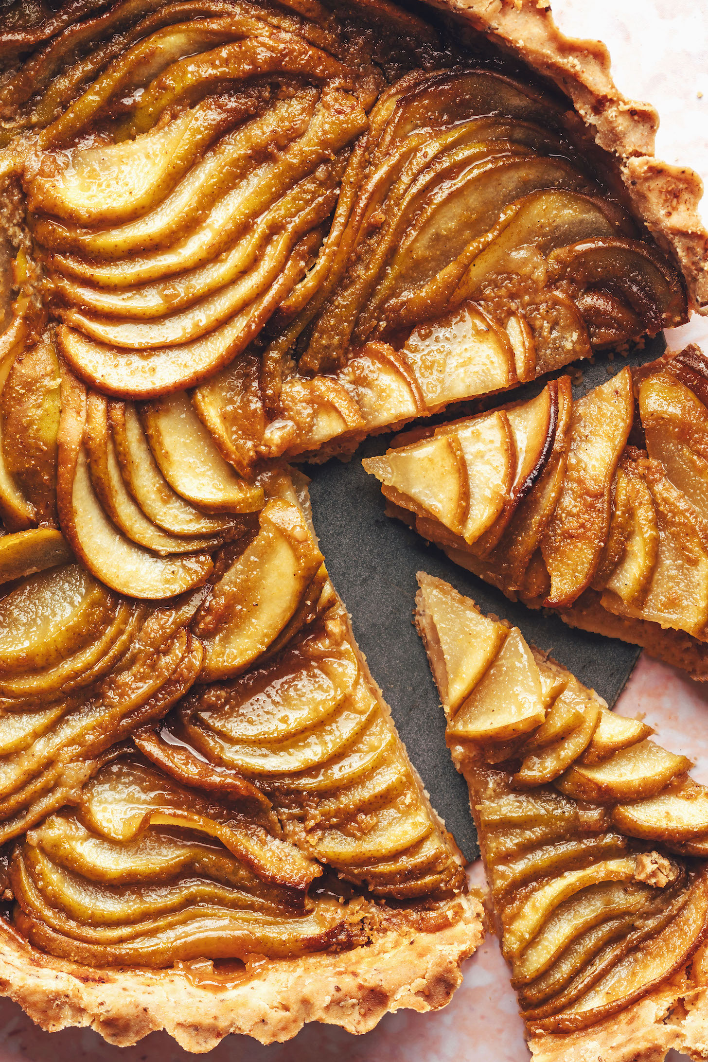 Two slices cut from the rest of the ginger pear tart