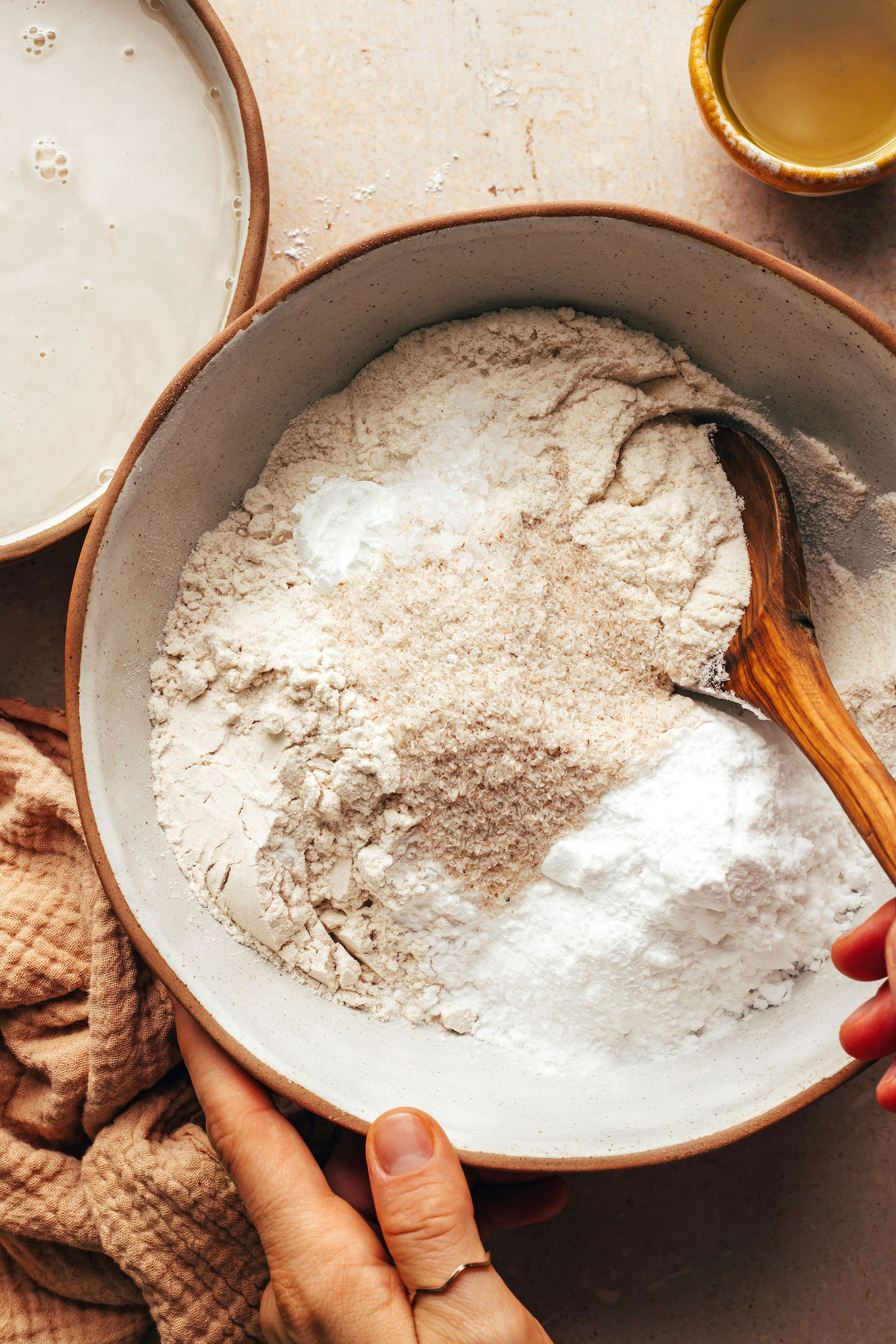 Stirring gluten-free flours, psyllium husk, salt, and baking powder in a bowl
