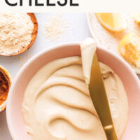 Knife resting over a bowl of homemade vegan cream cheese