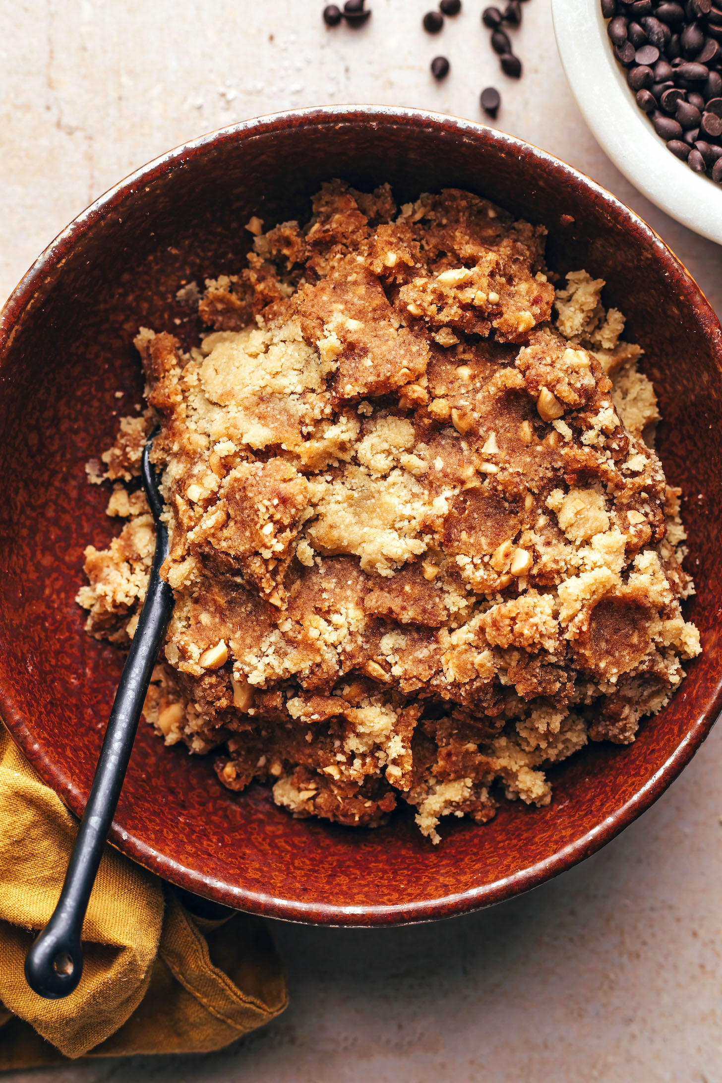 Bowl of snickers energy bite caramel and nougat mixtures stirred together