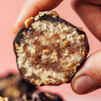 Holding up a snickers energy bite to show the swirl inside