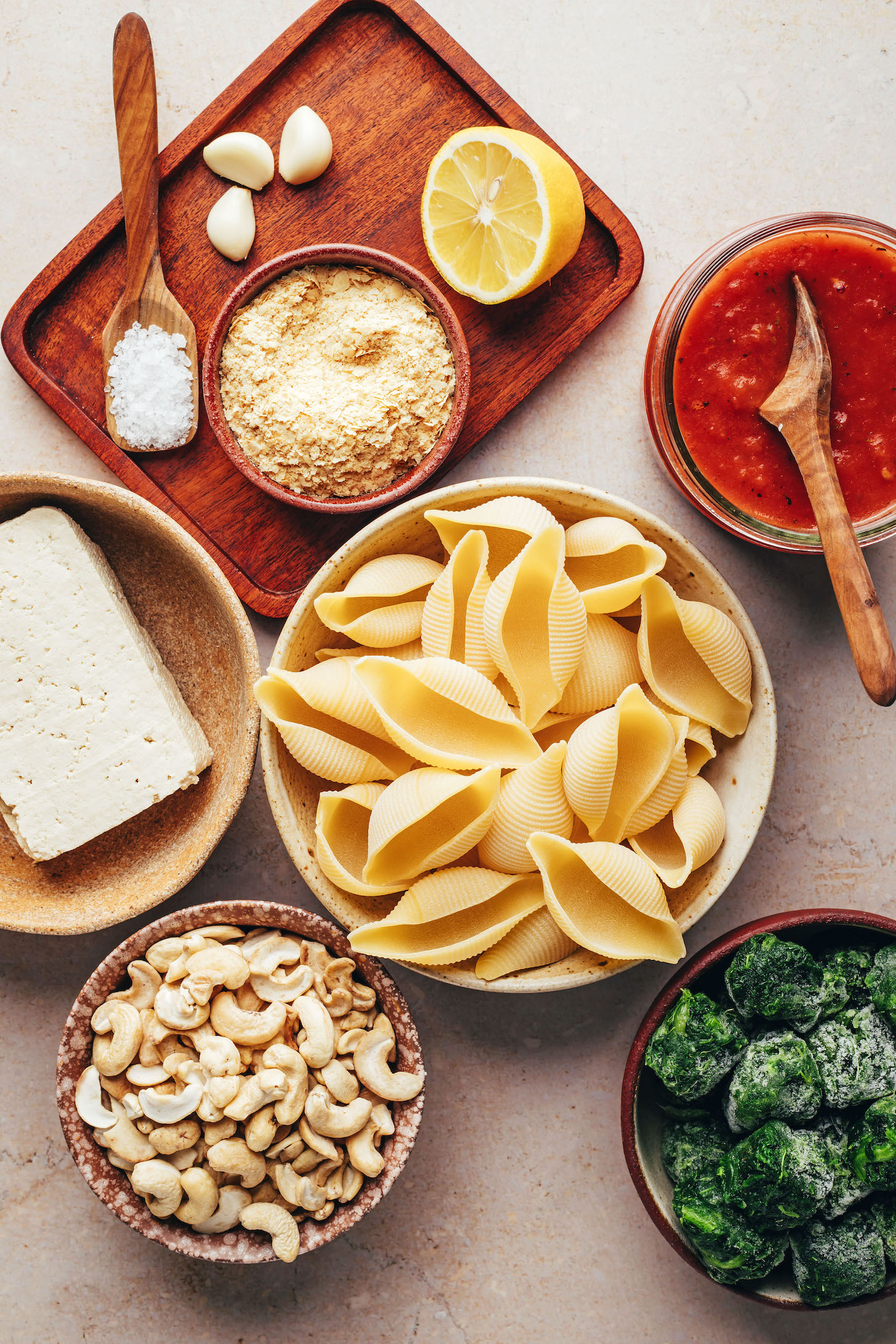 Spinach, cashews, pasta shells, tofu, salt, nutritional yeast, garlic, lemon, and marinara
