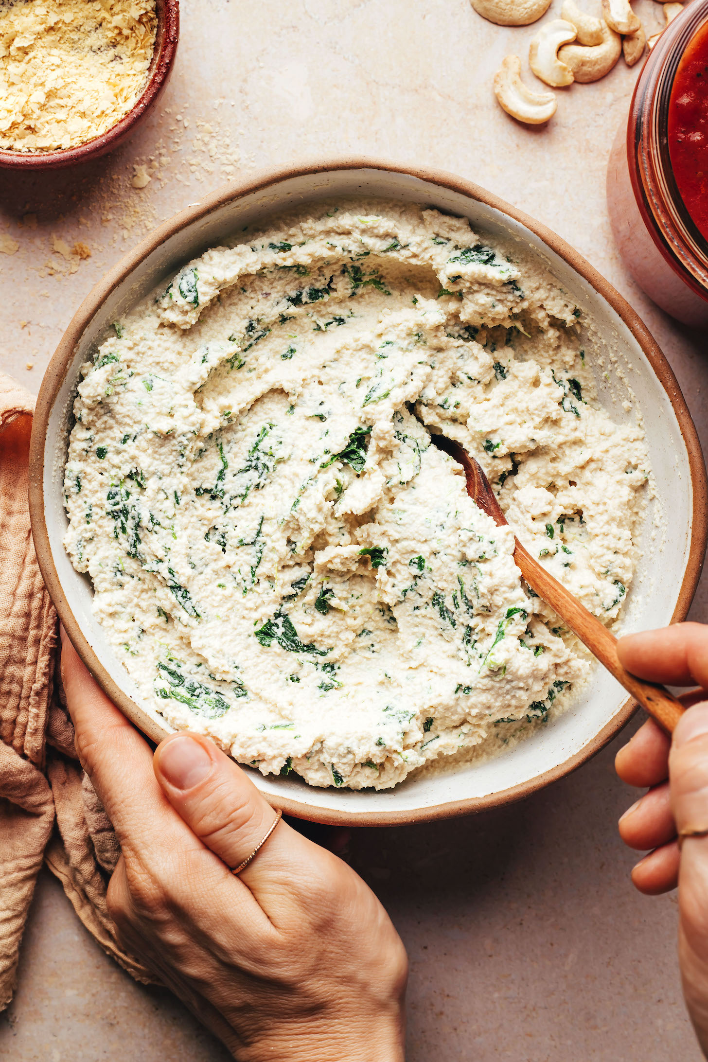 Bowl of cashew tofu ricotta with spinach stirred in
