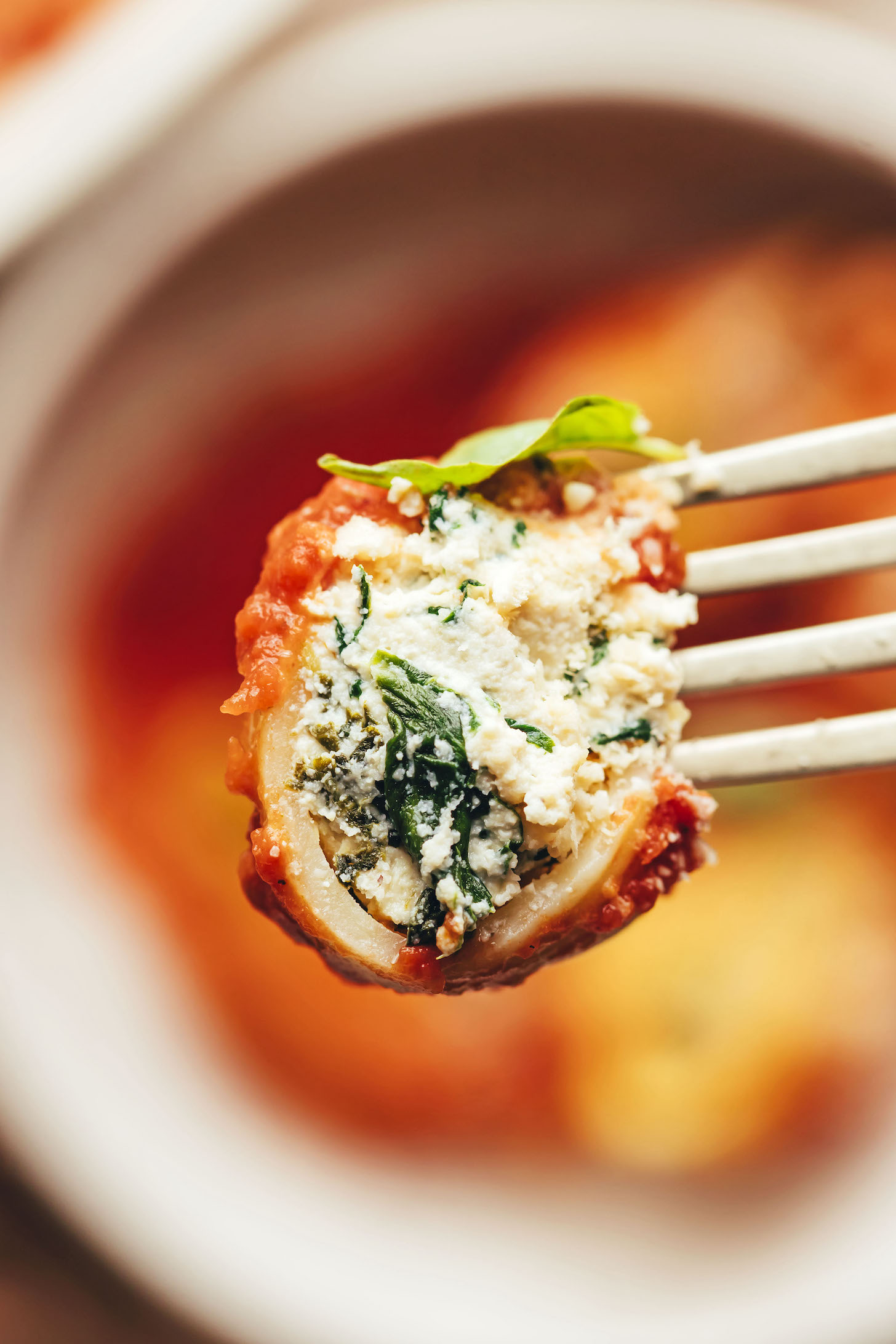 Close up shot of a vegan stuffed shell on a fork