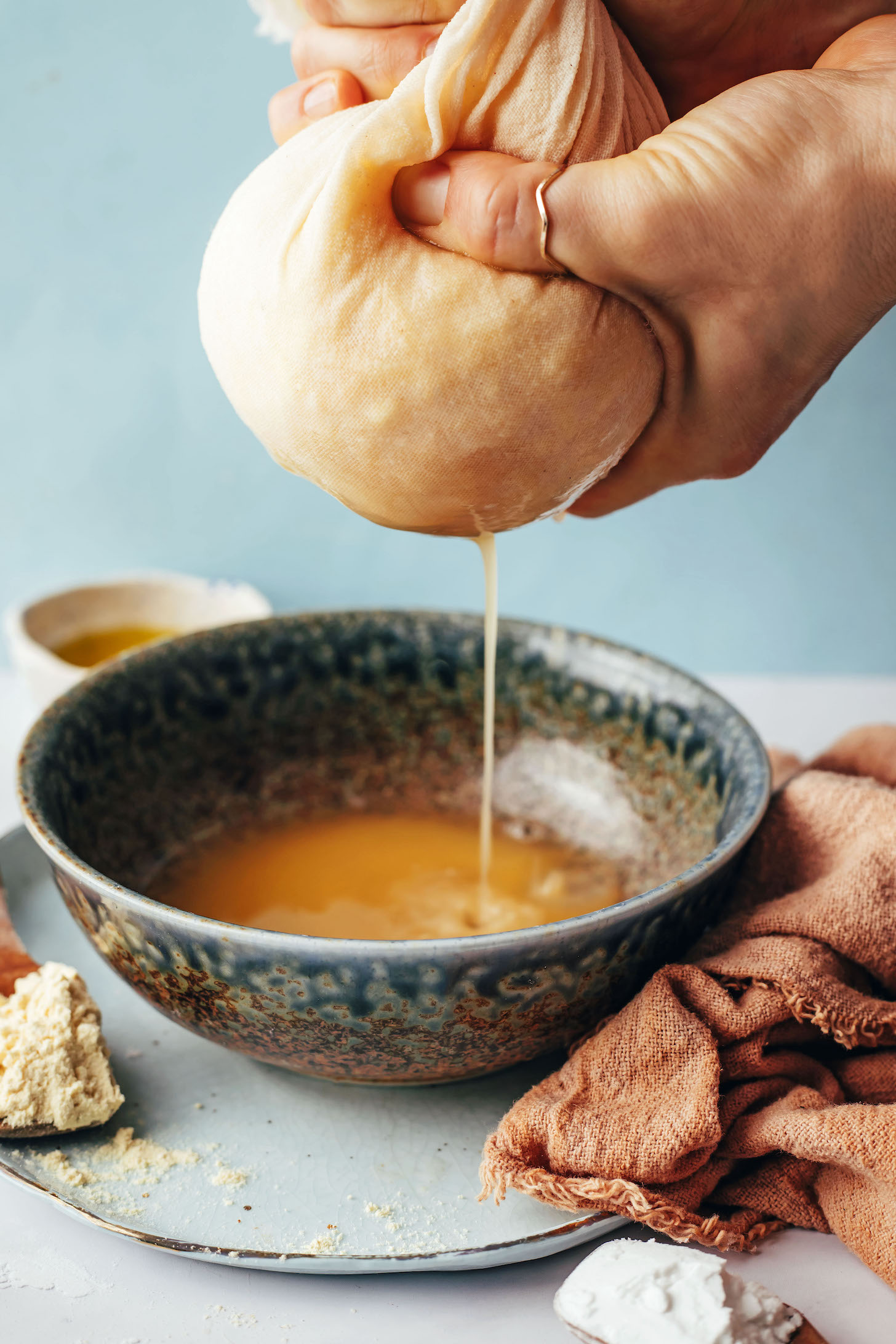 Squeezing out liquid from shredded potatoes and onions