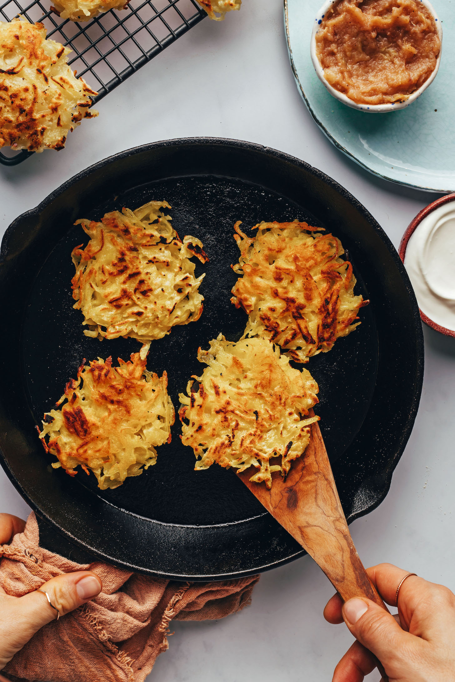 Cooking vegan gluten-free latkes in a cast iron skillet