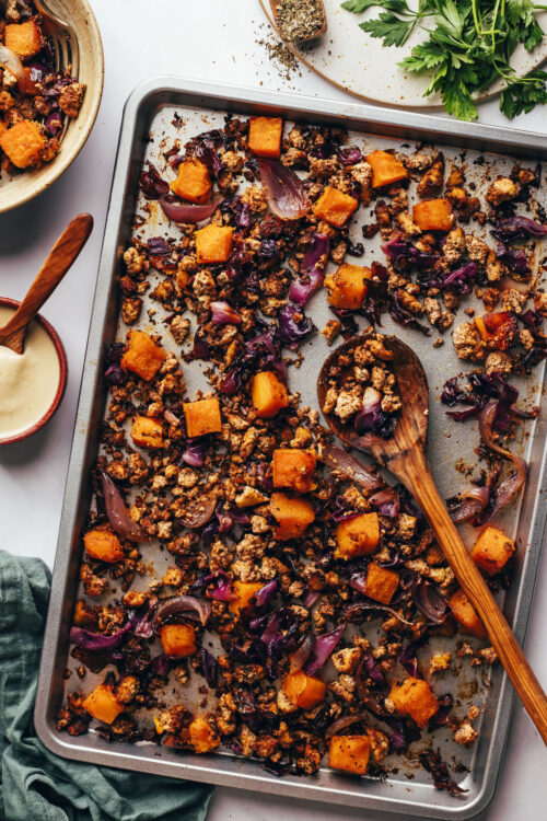 Wooden spoon on a pan of our tofu sheet pan dinner recipe