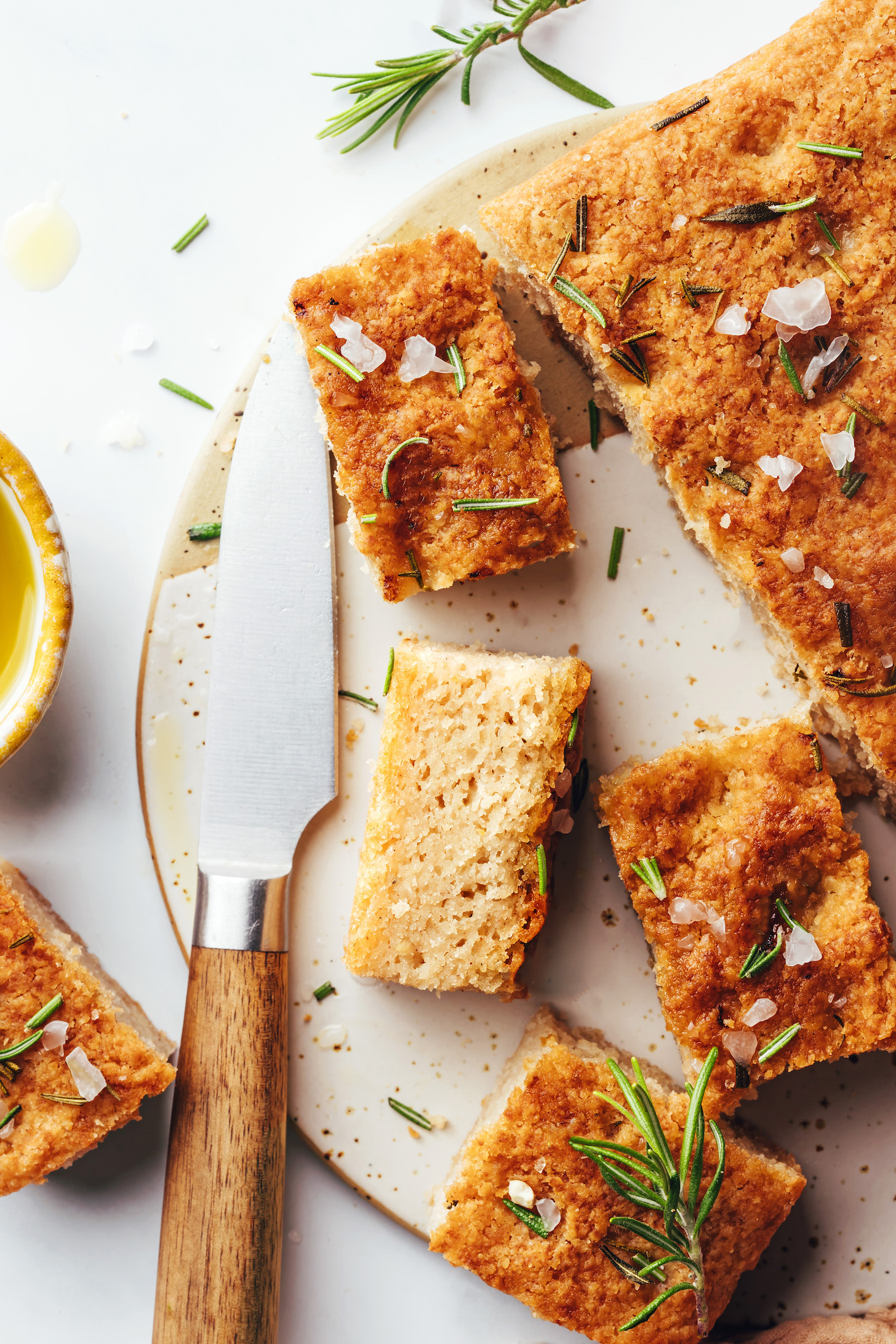 Slices of vegan gluten-free focaccia next to the rest of the loaf