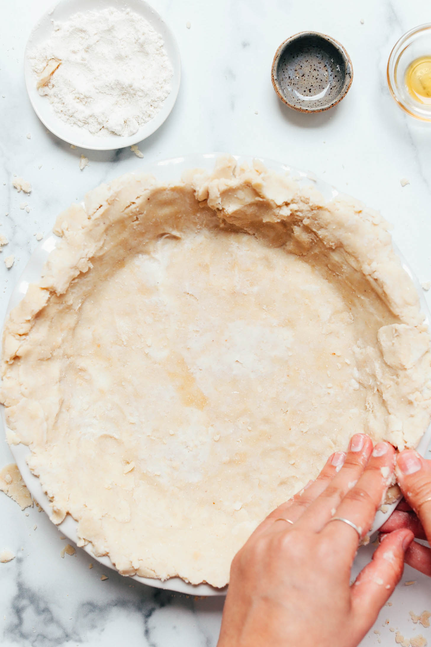 Smooshing the crust to remove any cracks