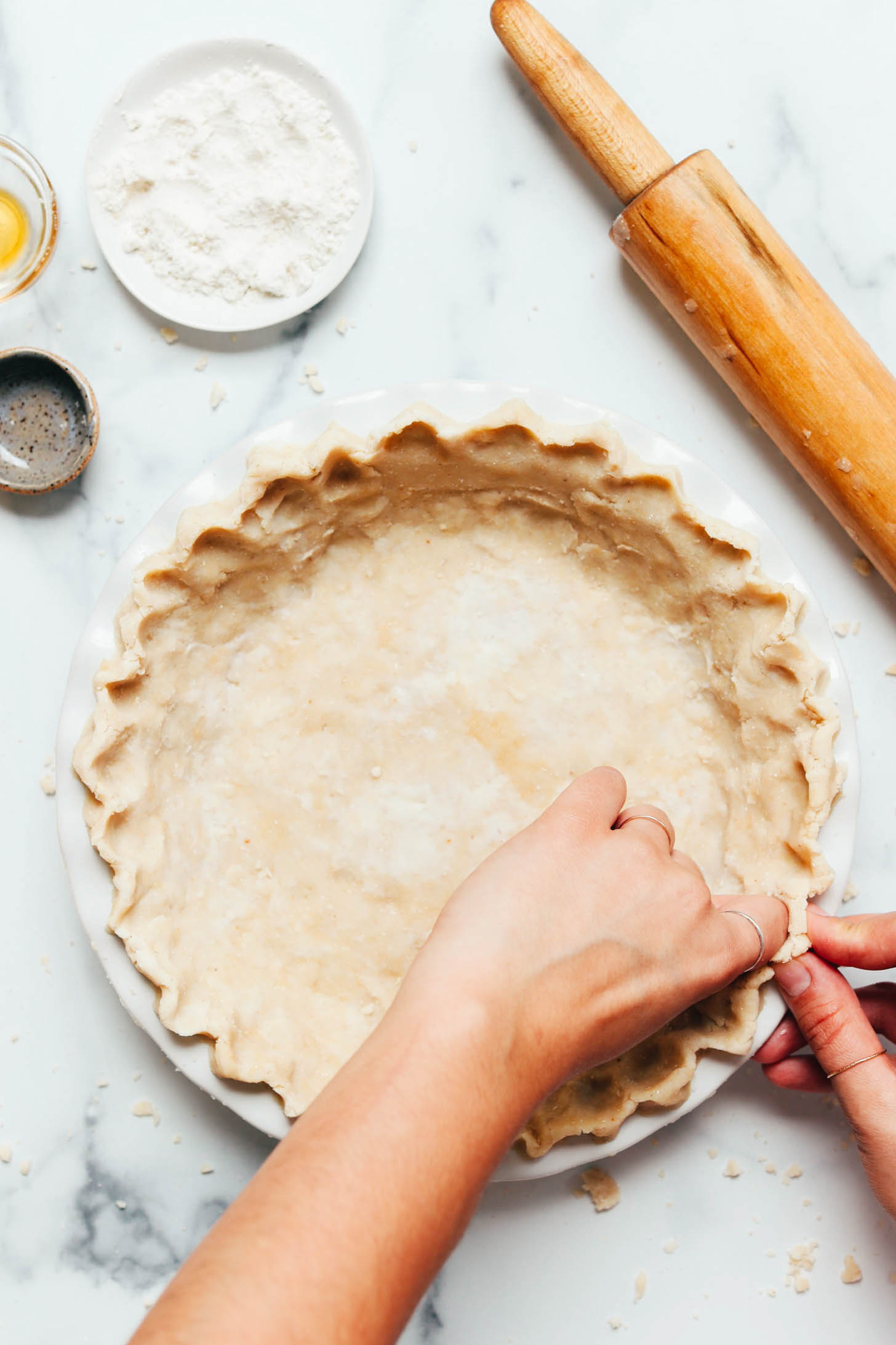 Crimping the edges of the pie crust