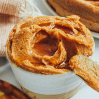 Butter knife resting on a bowl of pumpkin-spiced maple butter