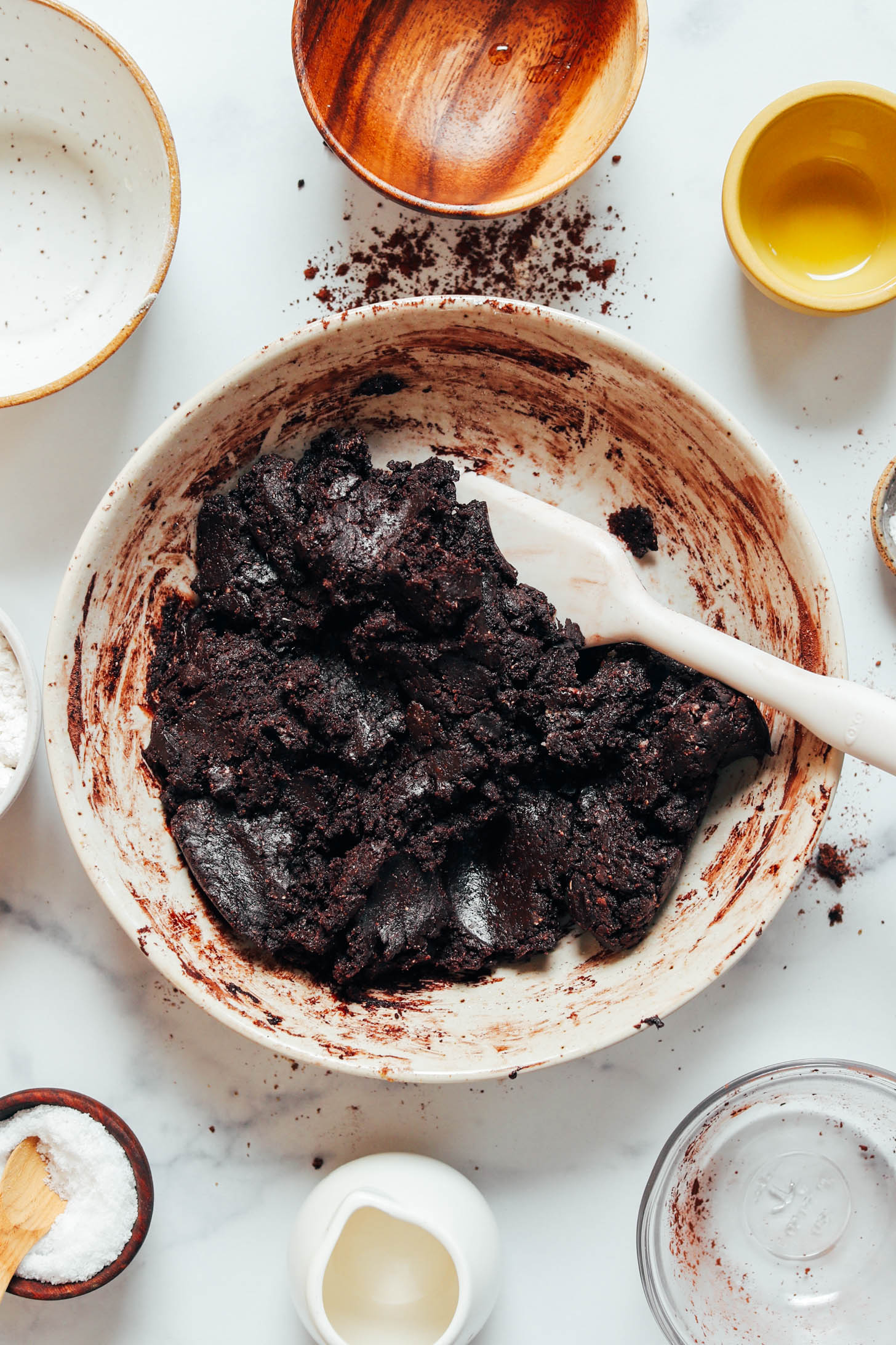 Rubber spatula in a bowl of chocolate crinkle cookie dough