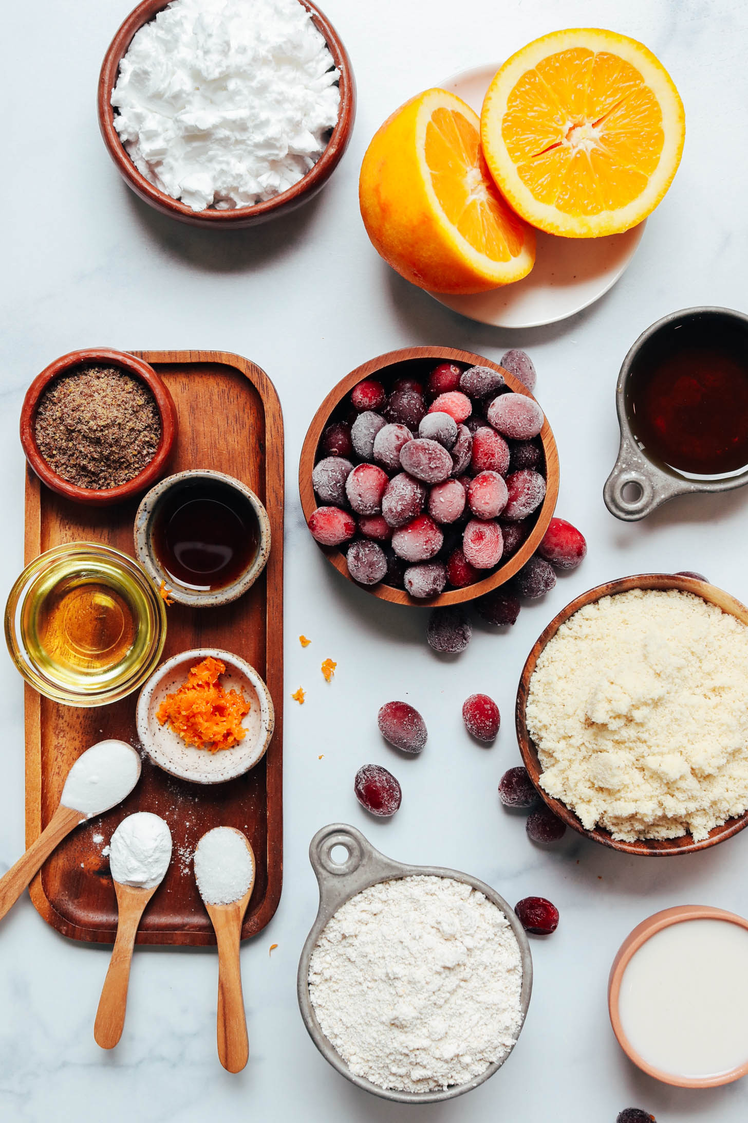 Potato starch, fresh orange, frozen cranberries, maple syrup, almond flour, dairy-free milk, oat flour, salt, baking soda, baking powder, orange zest, avocado oil, vanilla, and flax meal