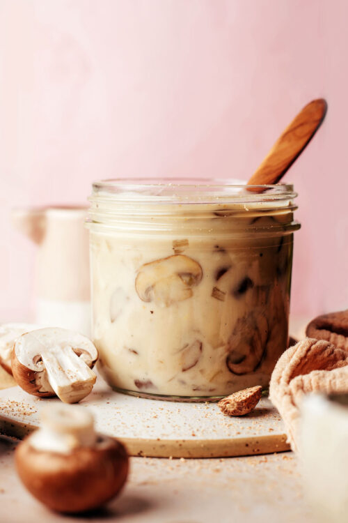 Mushrooms next to a jar of homemade vegan gluten free cream of mushroom soup